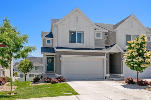 14929 S Beckenbauer Ave, Herriman, UT 84096 - view of front of property featuring board and batten siding, a garage, concrete driveway, and a front lawn