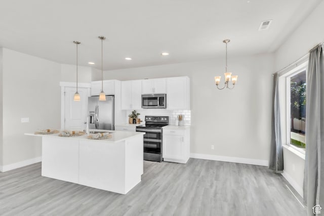 797 S Cowans Ct, Clearfield, UT 84015 - kitchen featuring stainless steel appliances, light wood-style floors, a chandelier, white cabinetry, and recessed lighting