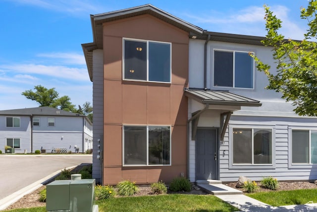 797 S Cowans Ct, Clearfield, UT 84015 - view of front of home featuring a standing seam roof, stucco siding, and a metal roof