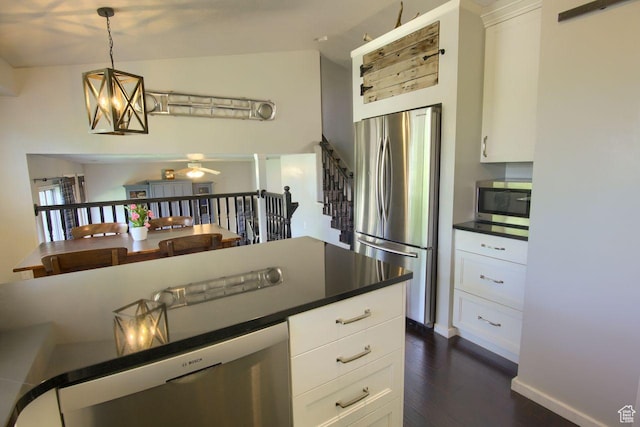1657 N Lewis And Clark Dr, Centerville, UT 84014 - kitchen with appliances with stainless steel finishes, dark wood-type flooring, dark countertops, and white cabinetry
