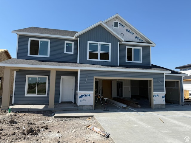 1174 W 3410 S, Nibley, UT 84321 - property under construction featuring driveway, an attached garage, a porch, and board and batten siding