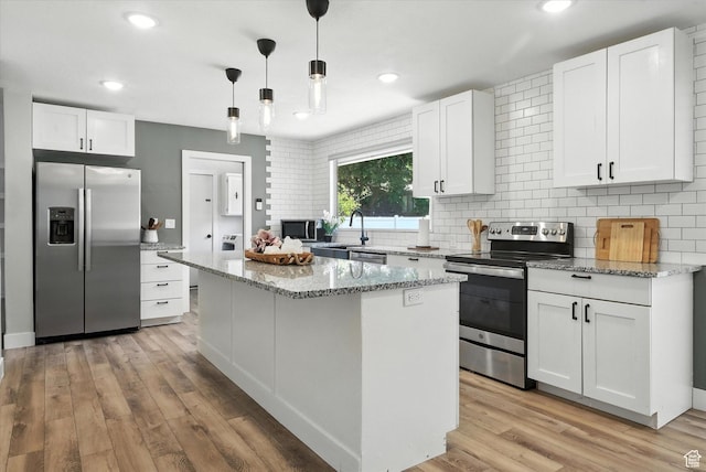 1520 N 1600 E, North Logan, UT 84341 - kitchen with appliances with stainless steel finishes, decorative backsplash, white cabinets, a center island, and recessed lighting