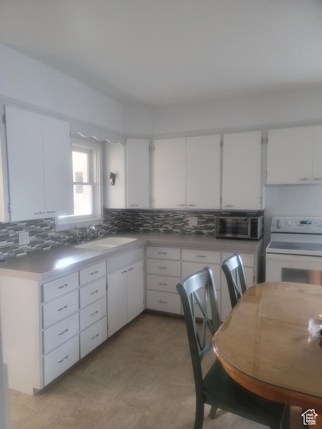 279 E 50 N, Moroni, UT 84646 - kitchen with white range with electric stovetop, decorative backsplash, and white cabinets