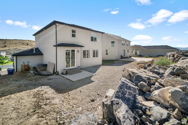 3712 E Long Ridge Dr Unit 124, Eagle Mountain, UT 84005 - back of house with a patio, stucco siding, and entry steps