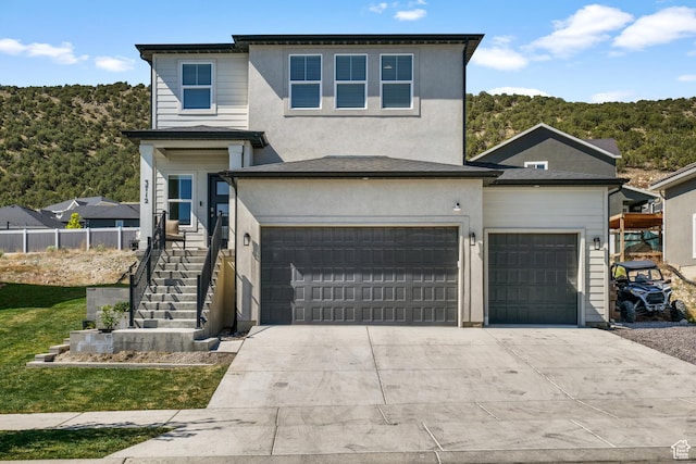 3712 E Long Ridge Dr Unit 124, Eagle Mountain, UT 84005 - traditional home featuring concrete driveway, an attached garage, stucco siding, and stairs
