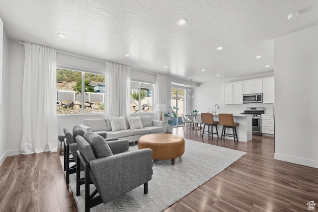 3712 E Long Ridge Dr Unit 124, Eagle Mountain, UT 84005 - living room featuring recessed lighting, dark wood finished floors, and a textured ceiling