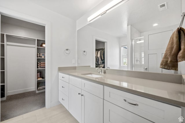 3712 E Long Ridge Dr Unit 124, Eagle Mountain, UT 84005 - bathroom with a spacious closet, vanity, and a stall shower