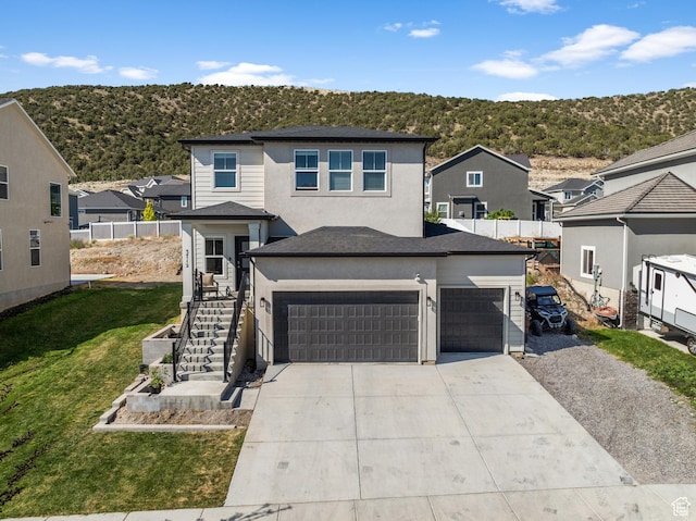 3712 E Long Ridge Dr Unit 124, Eagle Mountain, UT 84005 - traditional-style house featuring concrete driveway, a residential view, an attached garage, stairs, and stucco siding