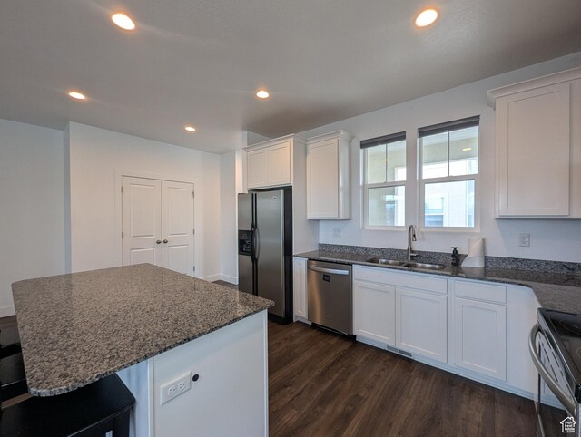 5427 W Ranches Loop Dr Unit 129, West Jordan, UT 84081 - kitchen featuring stainless steel appliances, dark wood-style flooring, white cabinets, dark stone countertops, and recessed lighting