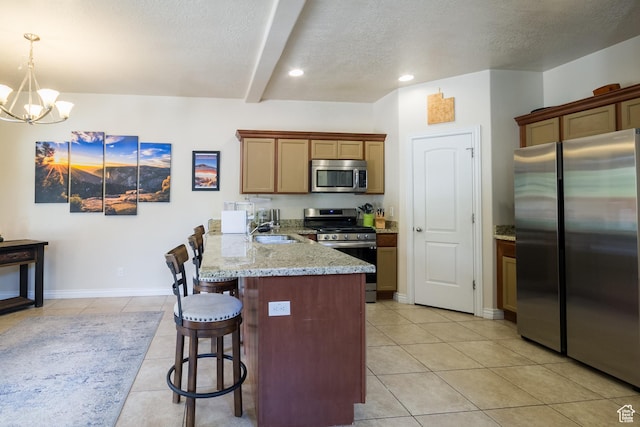 357 E 535 S, Vernal, UT 84078 - kitchen with stainless steel appliances, a peninsula, a textured ceiling, a kitchen bar, and light tile patterned flooring