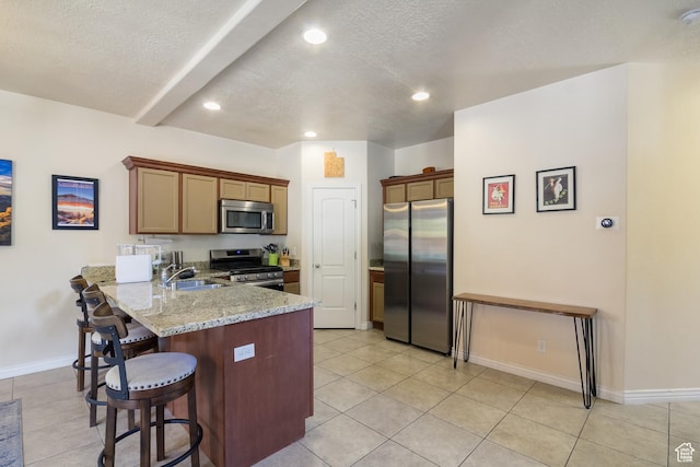 357 E 535 S, Vernal, UT 84078 - kitchen with appliances with stainless steel finishes, a peninsula, a breakfast bar area, a textured ceiling, and light tile patterned floors