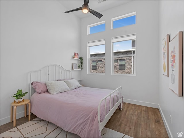 9217 S Holiday Bowl Ct E, Sandy, UT 84094 - bedroom with wood finished floors, a towering ceiling, and ceiling fan