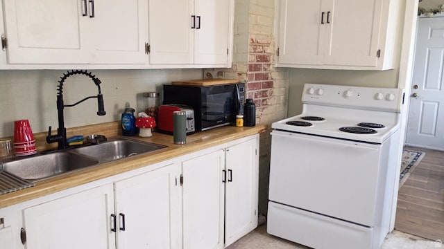 131 6th W, East Carbon, UT 84520 - kitchen featuring white range with electric stovetop and white cabinetry