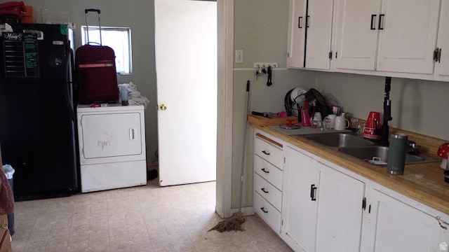131 6th W, East Carbon, UT 84520 - kitchen featuring freestanding refrigerator, white cabinets, and light countertops
