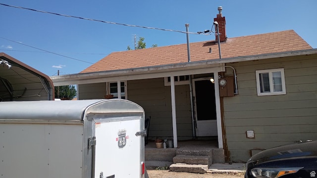 131 6th W, East Carbon, UT 84520 - exterior space with a shingled roof, a detached carport, and a chimney