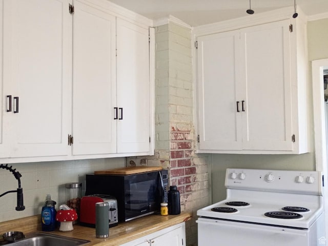 131 6th W, East Carbon, UT 84520 - kitchen with white electric stove, black microwave, white cabinets, backsplash, and light countertops