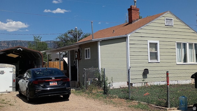 131 6th W, East Carbon, UT 84520 - view of side of home with a detached carport and a chimney