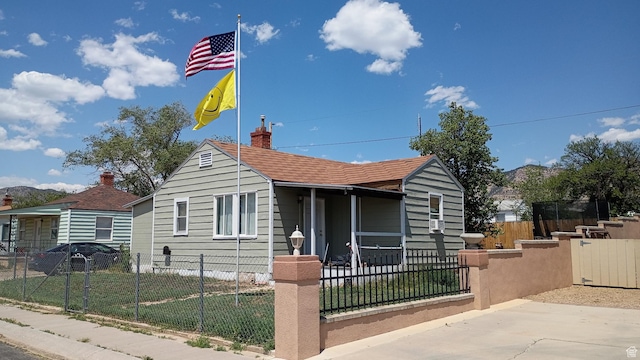 131 6th W, East Carbon, UT 84520 - bungalow-style home featuring a fenced front yard and a chimney