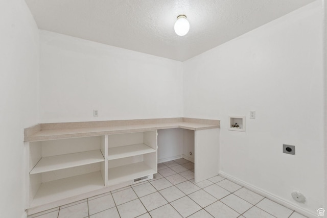 827 S 1030 W, Richfield, UT 84701 - laundry room featuring electric dryer hookup, hookup for a washing machine, a textured ceiling, and light tile patterned floors