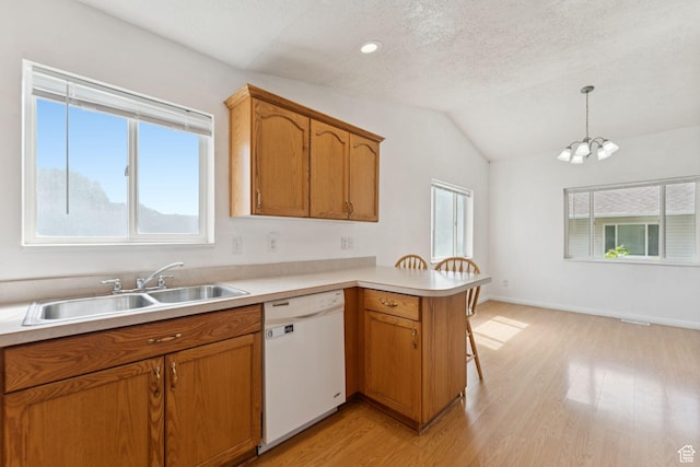 827 S 1030 W, Richfield, UT 84701 - kitchen featuring dishwasher, a peninsula, light wood-style flooring, lofted ceiling, and light countertops