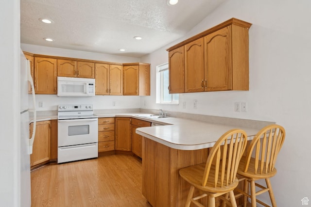 827 S 1030 W, Richfield, UT 84701 - kitchen with white appliances, a peninsula, light wood-style floors, recessed lighting, and light countertops