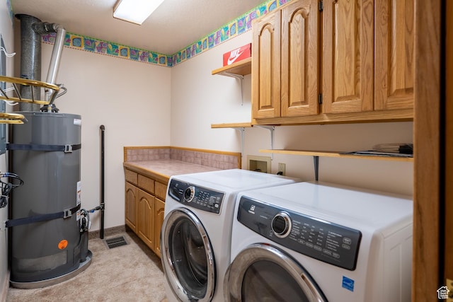 4163 S Beeman Rd, Moab, UT 84532 - washroom with strapped water heater, washer and dryer, light carpet, and cabinet space