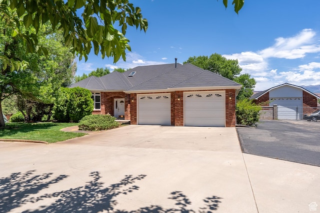 4163 S Beeman Rd, Moab, UT 84532 - ranch-style house featuring brick siding, an attached garage, driveway, and a front lawn