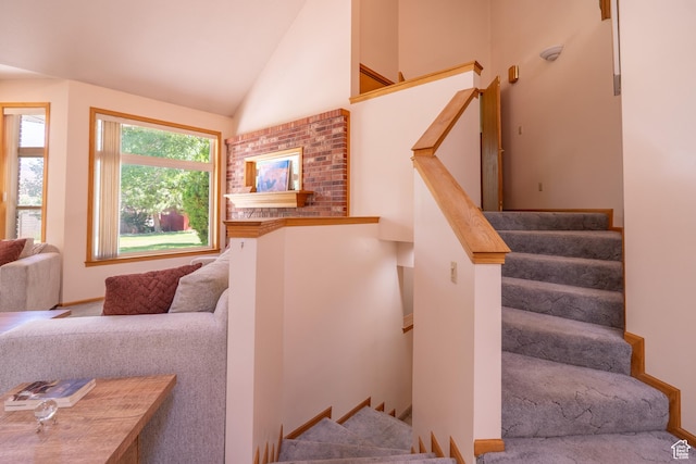 4163 S Beeman Rd, Moab, UT 84532 - stairway with high vaulted ceiling and carpet flooring