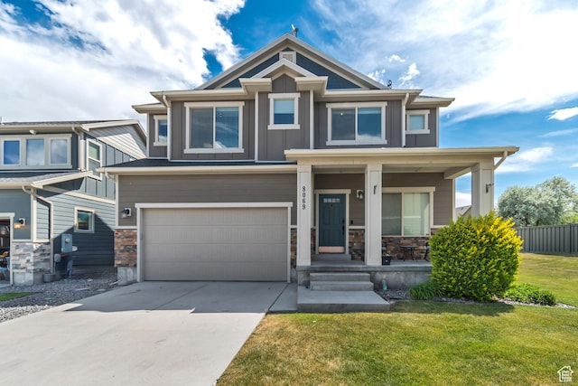 8069 N Quarter Mile Dr, Eagle Mountain, UT 84005 - view of front of property featuring a porch, board and batten siding, an attached garage, driveway, and stone siding