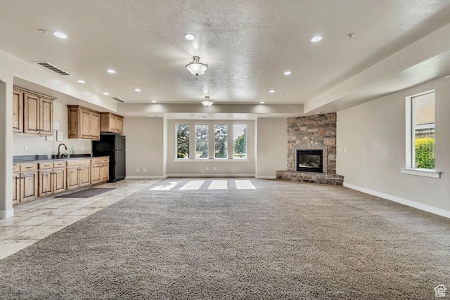 1045 S 1700 W Unit 1213, Payson, UT 84651 - unfurnished living room featuring recessed lighting, healthy amount of natural light, light carpet, a fireplace, and a textured ceiling