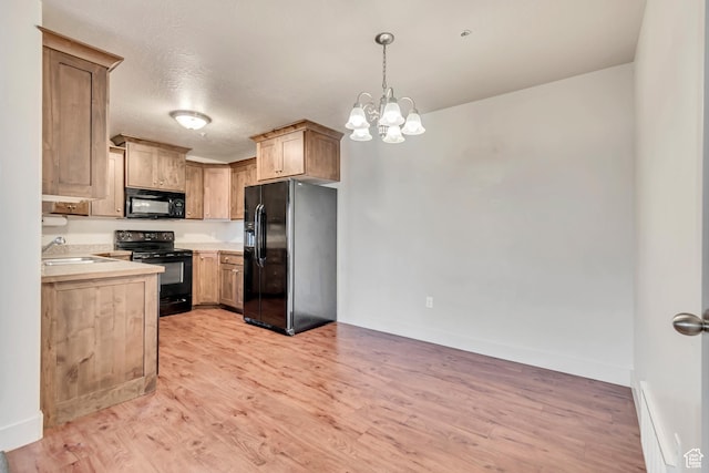 1045 S 1700 W Unit 1213, Payson, UT 84651 - kitchen featuring black appliances, light countertops, light wood-style floors, hanging light fixtures, and a chandelier