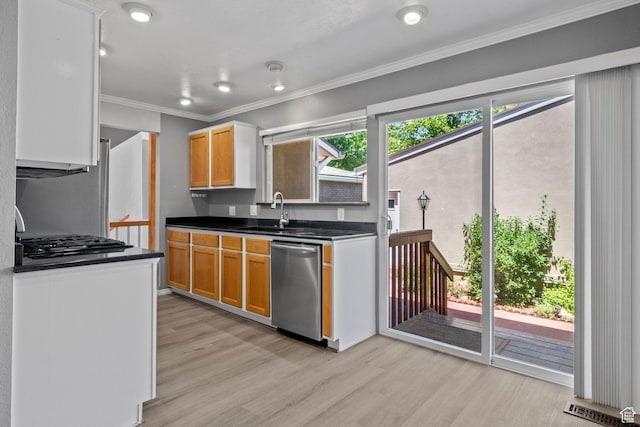 1870 E Monterey Dr, Salt Lake City, UT 84121 - kitchen with stainless steel dishwasher, light wood-style floors, dark countertops, gas stovetop, and ornamental molding