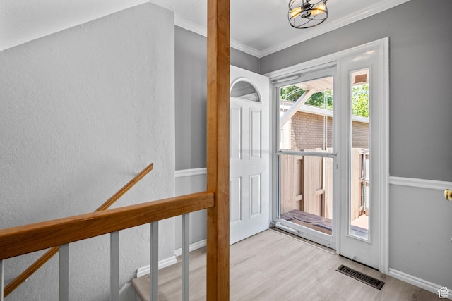 1870 E Monterey Dr, Salt Lake City, UT 84121 - doorway to outside with wood finished floors, crown molding, a chandelier, and a textured wall