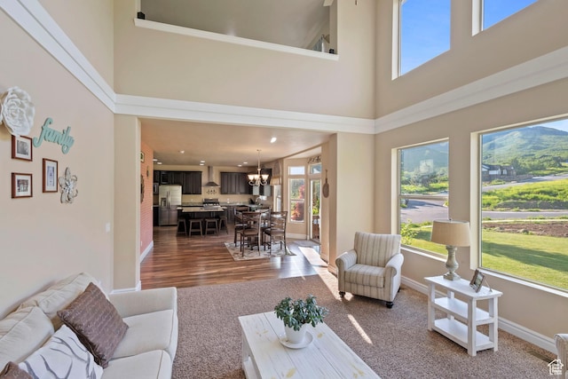 6284 Oak Ridge Ln, Mountain Green, UT 84050 - living area with a high ceiling, dark wood finished floors, a chandelier, and dark colored carpet