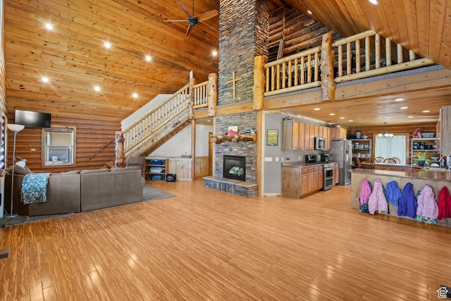 265 S 400 E, Centerfield, UT 84622 - living room with high vaulted ceiling, stairs, light wood finished floors, wood ceiling, and a fireplace