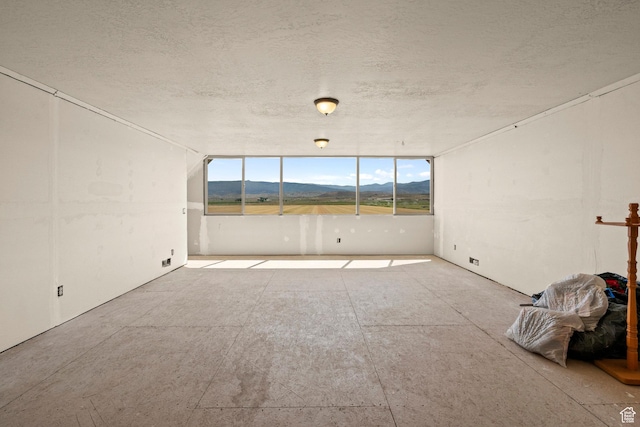 265 S 400 E, Centerfield, UT 84622 - empty room featuring a mountain view and a textured ceiling