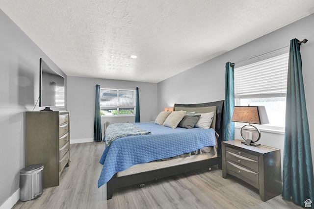 5057 W Eagle Rock Way, West Valley City, UT 84120 - bedroom featuring a textured ceiling and light wood finished floors