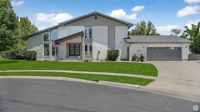 2550 W Lolene Cir, Taylorsville, UT 84129 - view of front of property with french doors, a garage, a front yard, driveway, and brick siding