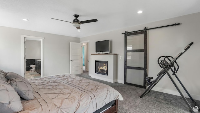 2550 W Lolene Cir, Taylorsville, UT 84129 - carpeted bedroom featuring a barn door, a glass covered fireplace, recessed lighting, connected bathroom, and ceiling fan