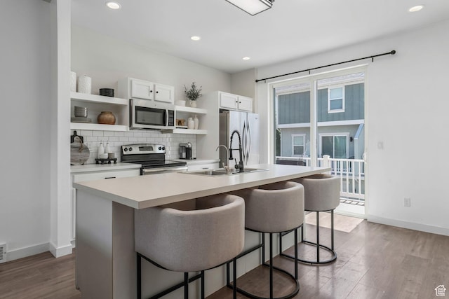 5124 W Stockfield Ln, Herriman, UT 84096 - kitchen featuring stainless steel appliances, open shelves, dark wood-type flooring, a kitchen breakfast bar, and recessed lighting