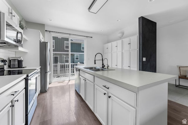 5124 W Stockfield Ln, Herriman, UT 84096 - kitchen featuring appliances with stainless steel finishes, light countertops, white cabinets, dark wood finished floors, and recessed lighting
