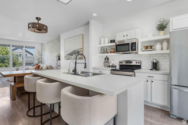 5124 W Stockfield Ln, Herriman, UT 84096 - kitchen with stainless steel appliances, open shelves, tasteful backsplash, light countertops, and recessed lighting