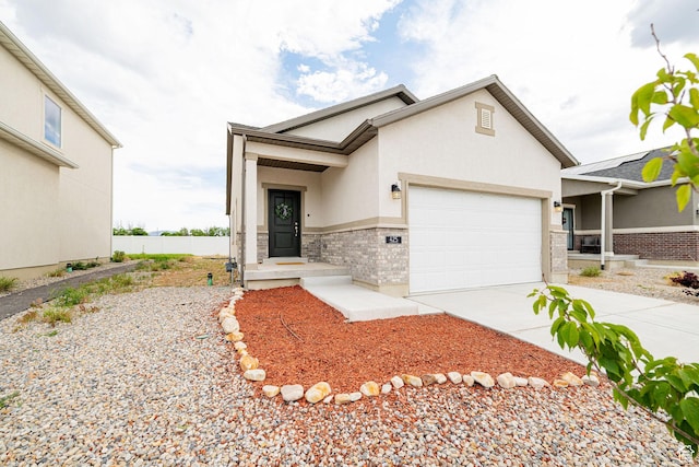 425 W Domain Ln, Grantsville, UT 84029 - view of front of home with an attached garage, driveway, and stucco siding