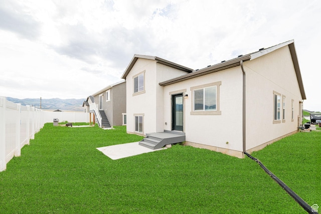 425 W Domain Ln, Grantsville, UT 84029 - back of house featuring a fenced backyard, stucco siding, and a mountain view