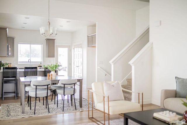 425 W Domain Ln, Grantsville, UT 84029 - dining area featuring stairs, light wood-style flooring, and a chandelier