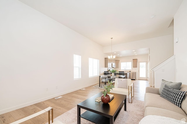 425 W Domain Ln, Grantsville, UT 84029 - living room with a chandelier and light wood-style floors