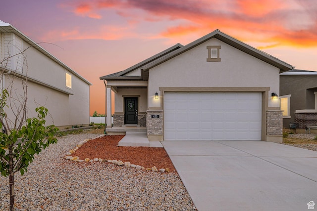 425 W Domain Ln, Grantsville, UT 84029 - view of front of house featuring stucco siding, a garage, driveway, and stone siding