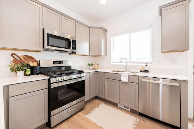 425 W Domain Ln, Grantsville, UT 84029 - kitchen with stainless steel appliances, light wood-style floors, light countertops, and gray cabinets