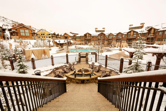 2100 W Frostwood Blvd Unit 4175, Park City, UT 84098 - snow covered back of property with a residential view, a fire pit, a patio, and view of pool area