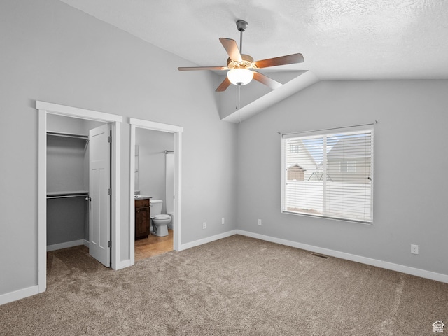 517 E 1140 S, Roosevelt, UT 84066 - unfurnished bedroom with carpet flooring, a walk in closet, lofted ceiling, connected bathroom, and a closet